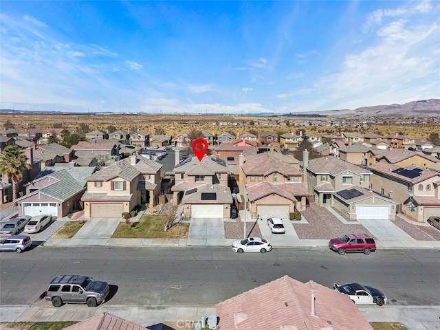 birds eye view of property with a mountain view