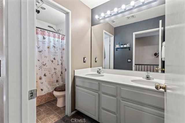 bathroom with vanity, curtained shower, and toilet