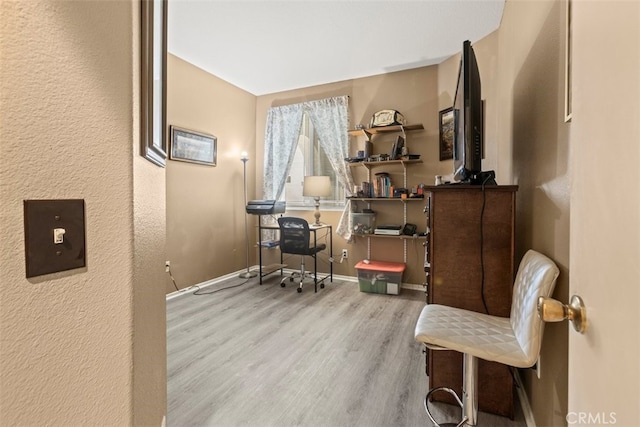 office area with light hardwood / wood-style floors