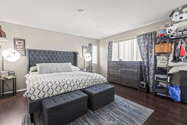 bedroom with dark hardwood / wood-style flooring