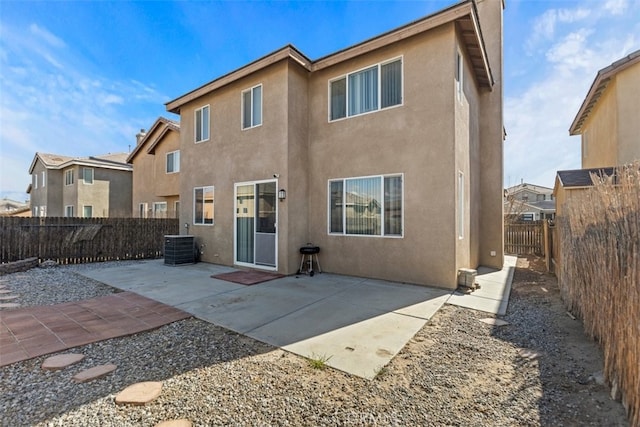 rear view of house featuring cooling unit and a patio area