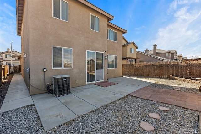 rear view of house featuring cooling unit and a patio area