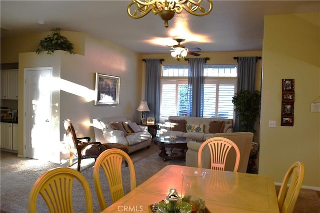 dining space featuring ceiling fan and carpet