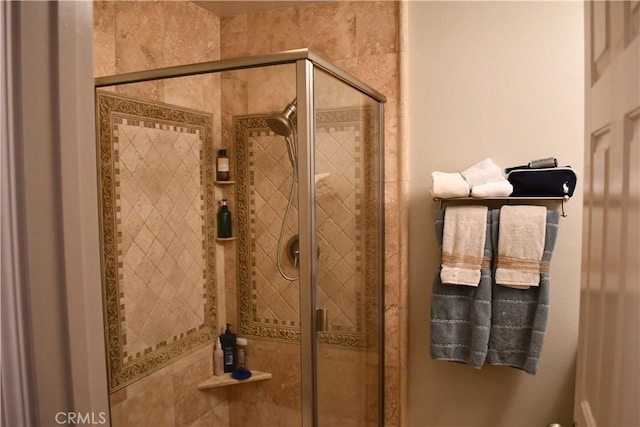 bathroom featuring a shower with door