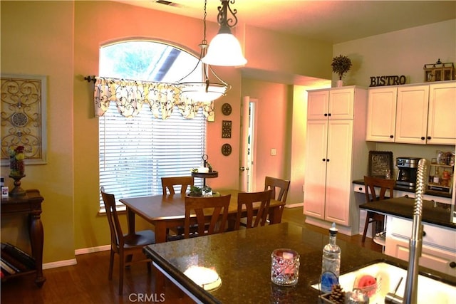 dining room with dark hardwood / wood-style flooring