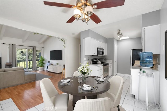 tiled dining space with vaulted ceiling with beams