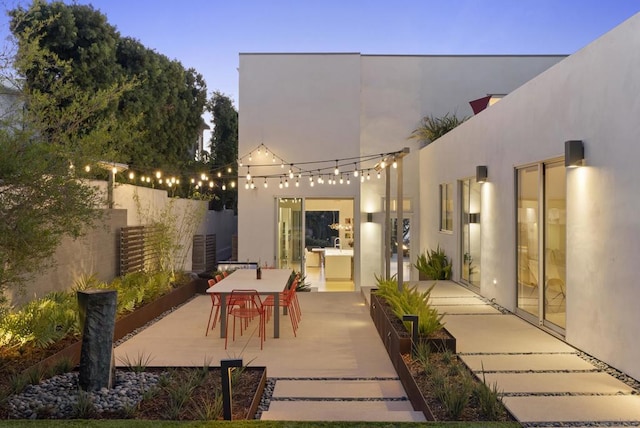 view of patio terrace at dusk