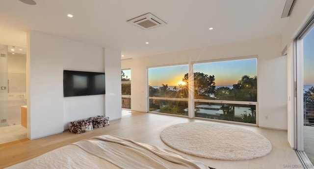 interior space with connected bathroom and light hardwood / wood-style floors