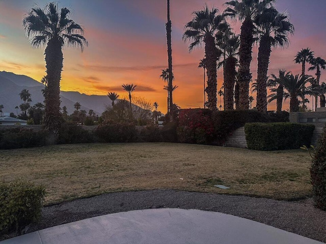 yard at dusk featuring a mountain view