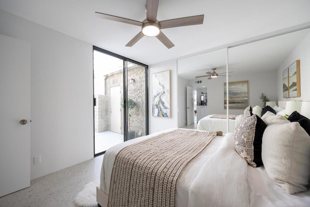 bedroom featuring ceiling fan, access to exterior, and a wall of windows