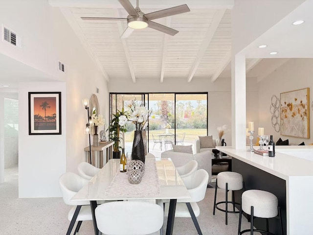 dining room featuring beam ceiling, wooden ceiling, and ceiling fan