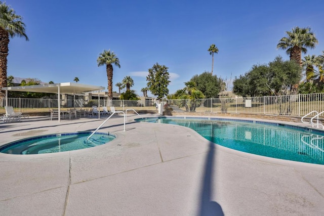 view of pool with a community hot tub and a patio