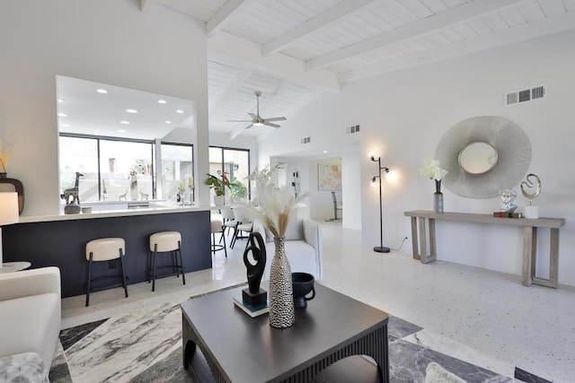 living room featuring ceiling fan, high vaulted ceiling, wooden ceiling, and beamed ceiling