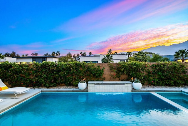 pool at dusk with a mountain view