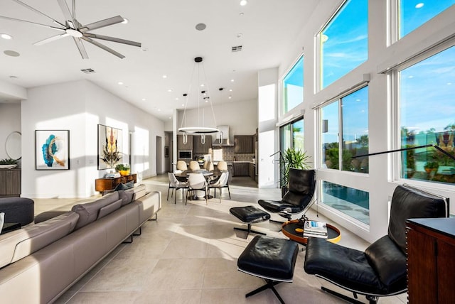 tiled living room featuring a towering ceiling