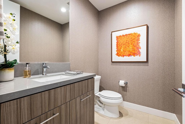 bathroom featuring tile patterned flooring, vanity, and toilet