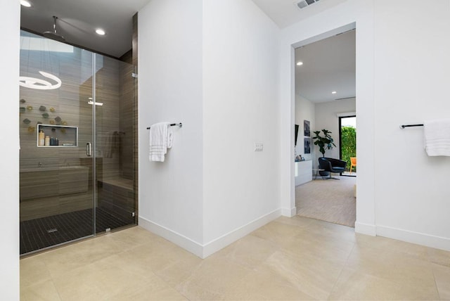 bathroom featuring a shower with shower door