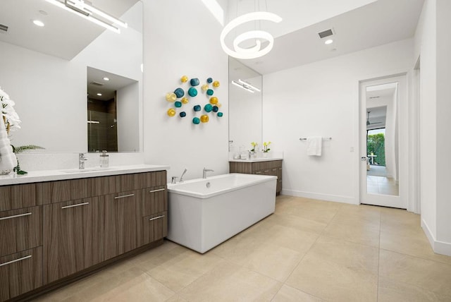 bathroom featuring tile patterned floors, vanity, and shower with separate bathtub