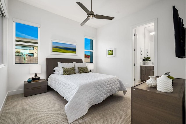 carpeted bedroom with ceiling fan and connected bathroom