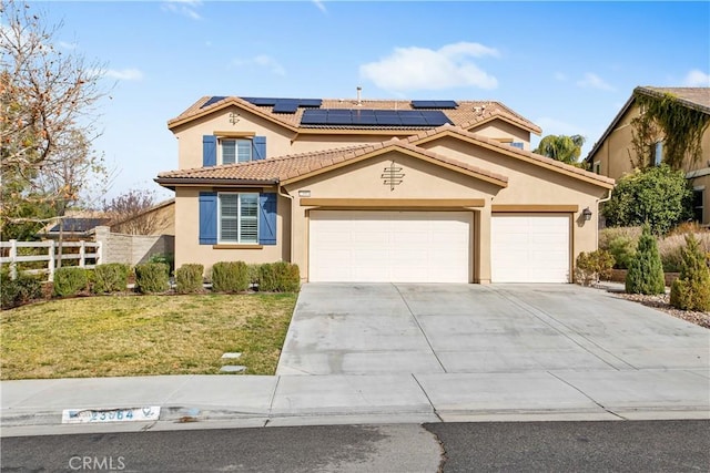 mediterranean / spanish-style home with concrete driveway, a front yard, fence, and stucco siding