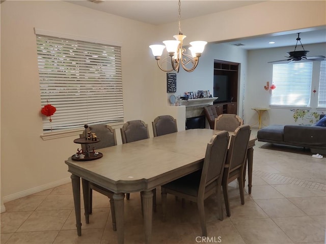 dining area featuring ceiling fan with notable chandelier and light tile patterned floors