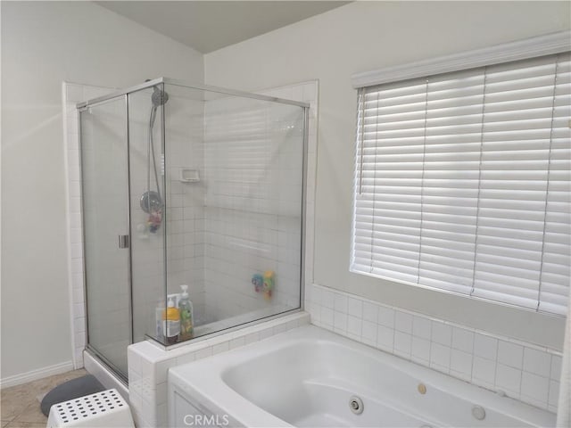 bathroom featuring plenty of natural light, independent shower and bath, and tile patterned flooring