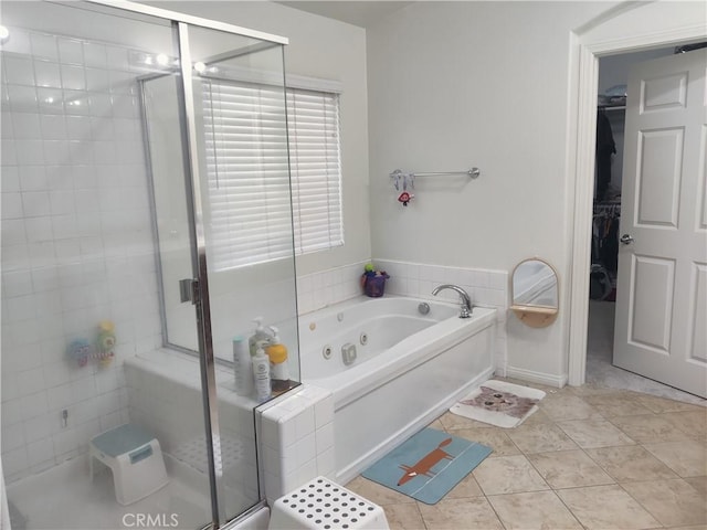 bathroom featuring tile patterned flooring and separate shower and tub