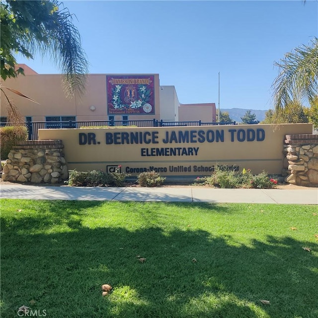 community / neighborhood sign with a lawn