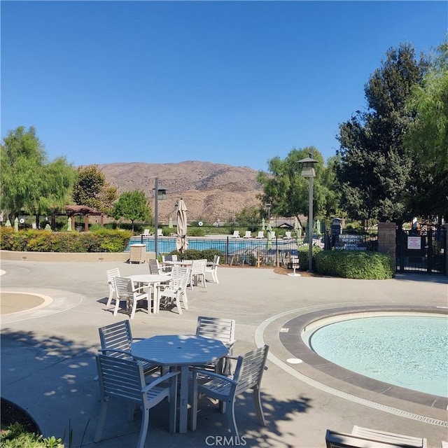 view of pool with a mountain view and a patio