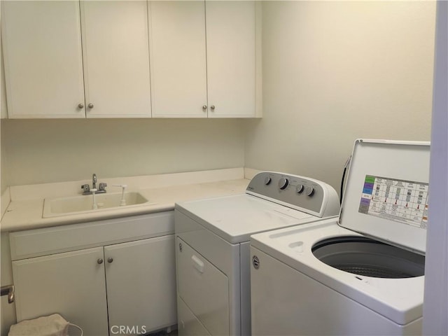 washroom with independent washer and dryer, cabinets, and sink