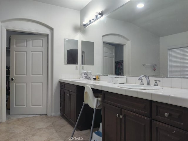 bathroom with vanity and lofted ceiling