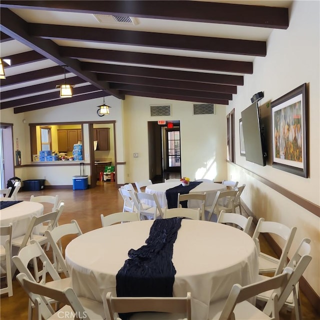 dining room featuring wood-type flooring and lofted ceiling with beams