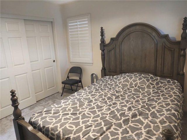 bedroom featuring light carpet and a closet