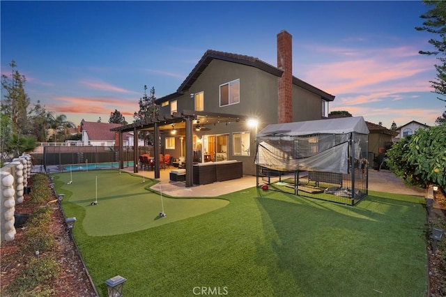 back house at dusk with an outdoor living space, a patio, and a pergola