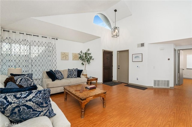 living room with wood-type flooring and vaulted ceiling