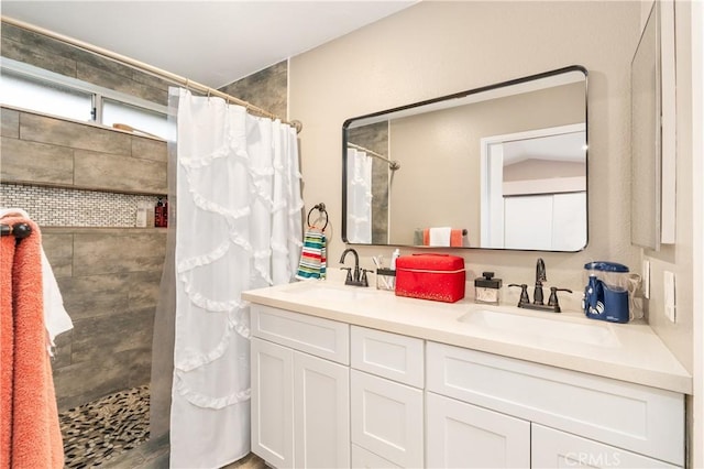 bathroom featuring vanity and a shower with shower curtain