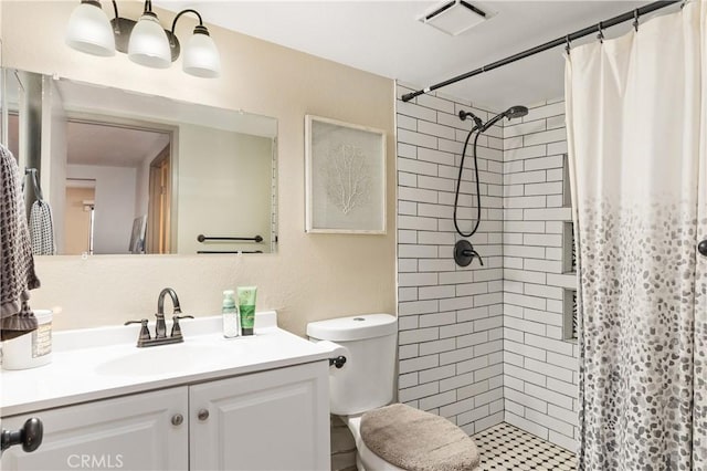 bathroom with vanity, curtained shower, and toilet