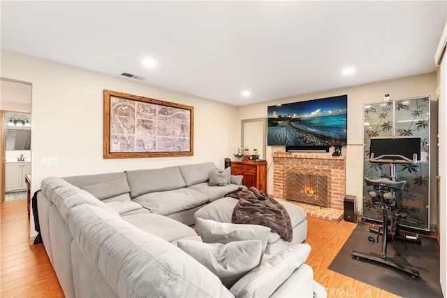 living room featuring wood-type flooring and a fireplace