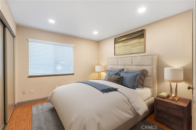 bedroom with hardwood / wood-style flooring and a closet