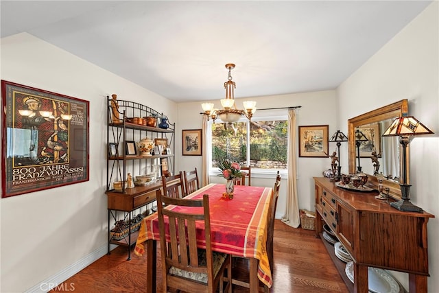 dining space featuring an inviting chandelier and dark hardwood / wood-style flooring