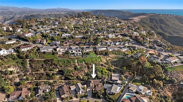 drone / aerial view with a water and mountain view