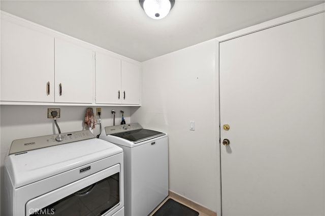 laundry area with washer and dryer and cabinets