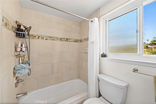 bathroom with shower / bath combo and toilet