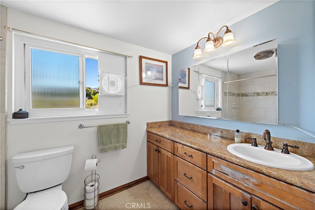 bathroom with tile patterned flooring, vanity, tiled shower, and toilet