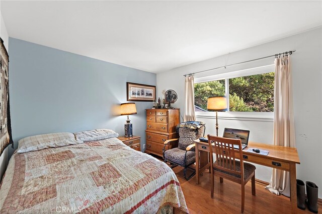 bedroom with wood-type flooring