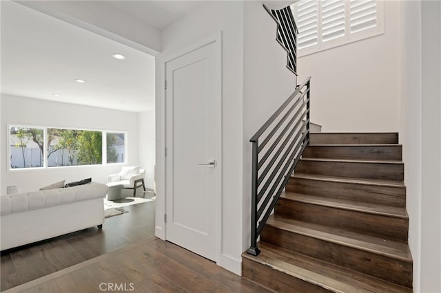 stairs with hardwood / wood-style flooring