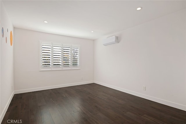 unfurnished room with dark hardwood / wood-style flooring and a wall mounted AC