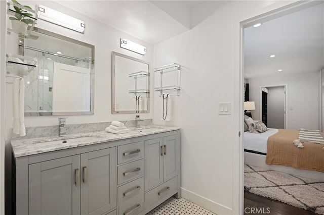 bathroom featuring vanity and a shower with door