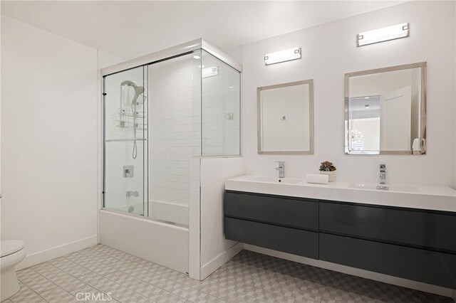 full bathroom with vanity, combined bath / shower with glass door, and toilet