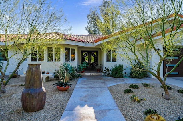 view of front of property with a garage and french doors